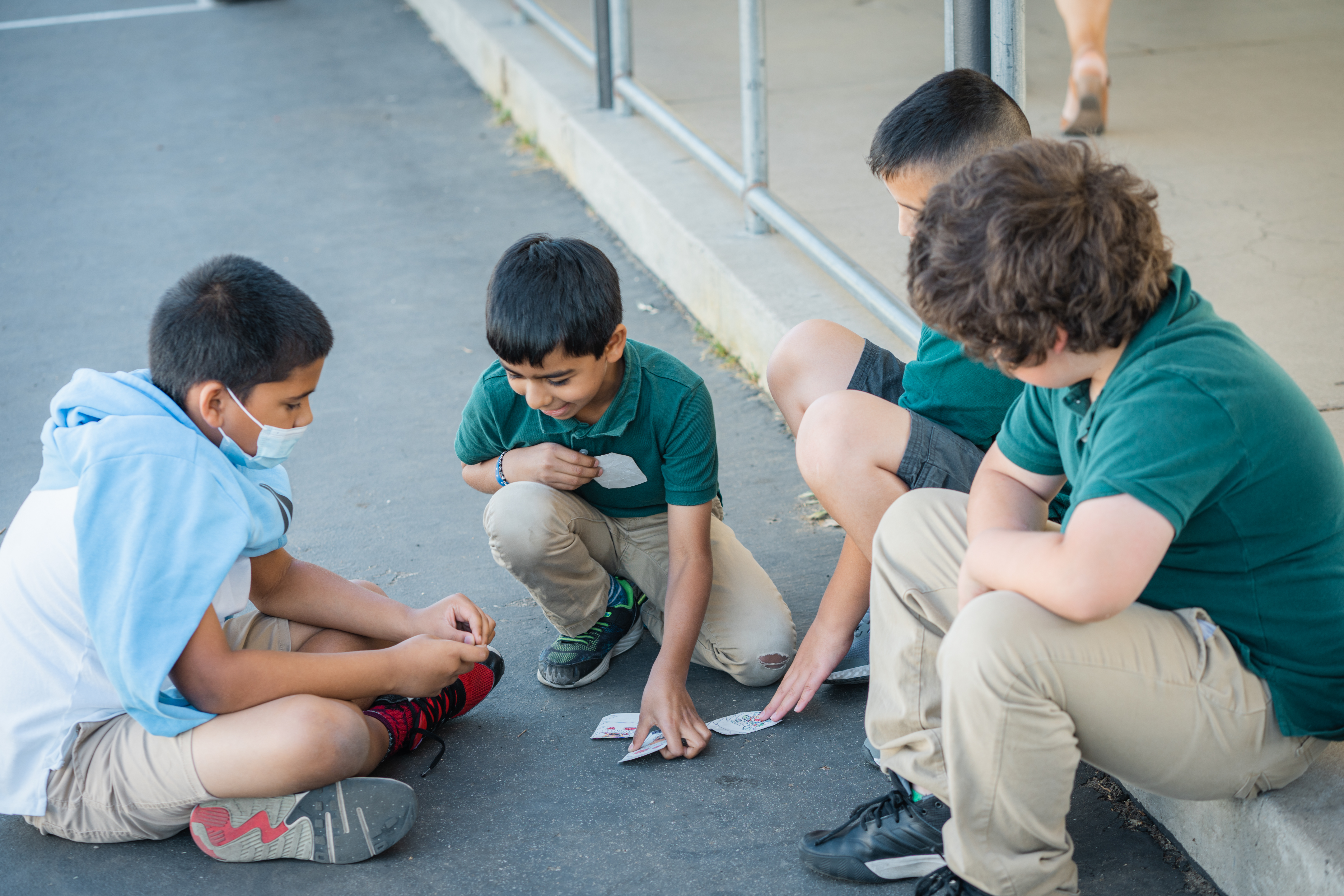 ASA Students at Recess playing a card game